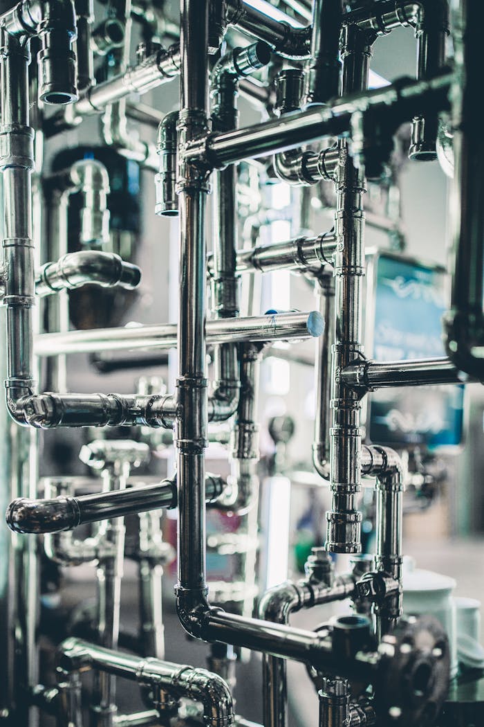 Services Close-up of complex stainless steel pipes in an industrial setting, showcasing modern engineering.